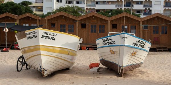Colorful fishing boats resting on sandy Monte Gordo beach, Faro, Portugal.